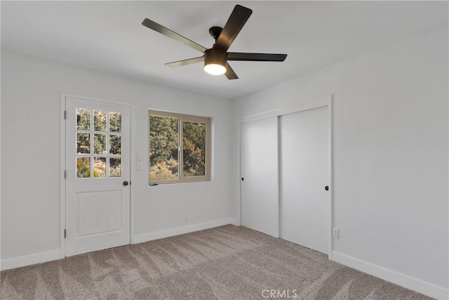 unfurnished bedroom with ceiling fan, a closet, and carpet floors