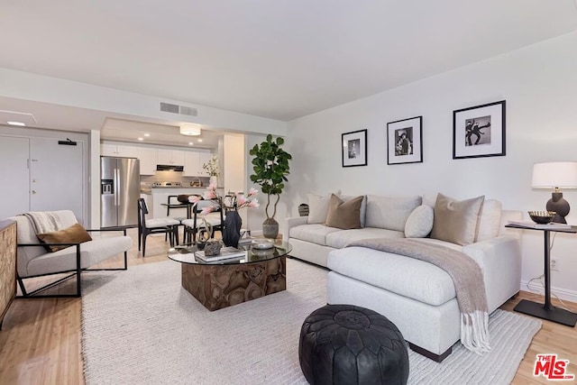 living room with light hardwood / wood-style floors