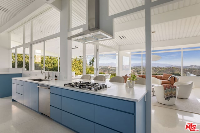 sunroom featuring a mountain view and sink