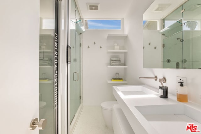 bathroom featuring an enclosed shower, vanity, and toilet