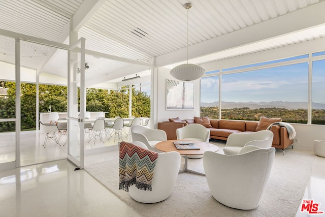 sunroom / solarium featuring a mountain view and plenty of natural light