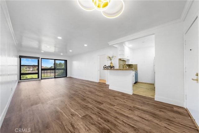 unfurnished living room featuring dark hardwood / wood-style floors and ornamental molding