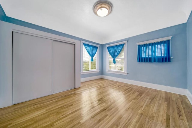 unfurnished bedroom featuring a closet and light hardwood / wood-style flooring