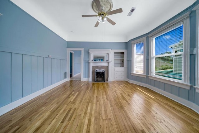 unfurnished living room with ceiling fan and light hardwood / wood-style floors