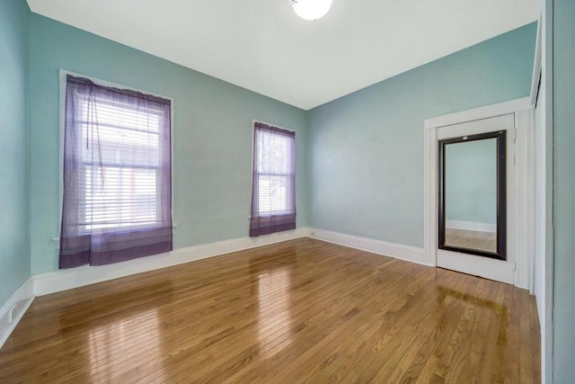 unfurnished room featuring hardwood / wood-style floors