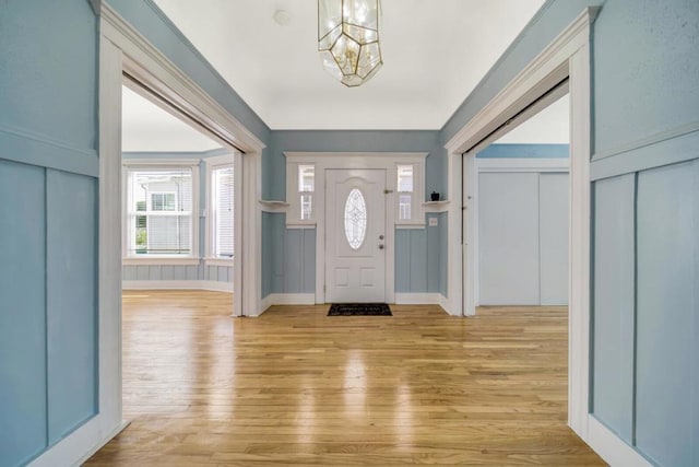 entrance foyer featuring light hardwood / wood-style flooring and an inviting chandelier