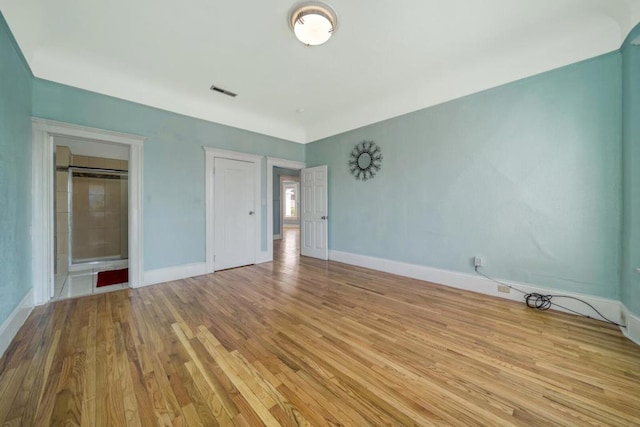 unfurnished bedroom with light wood-type flooring