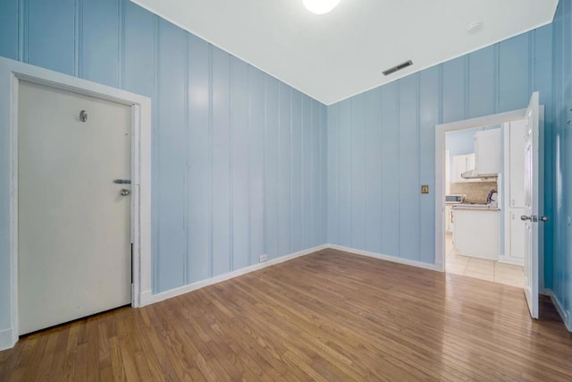 spare room featuring light hardwood / wood-style flooring