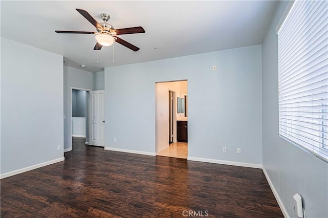 unfurnished room with ceiling fan and dark wood-type flooring