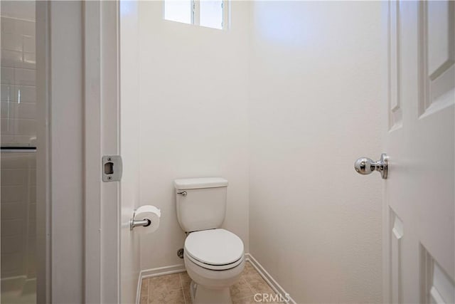 bathroom featuring tile patterned flooring and toilet