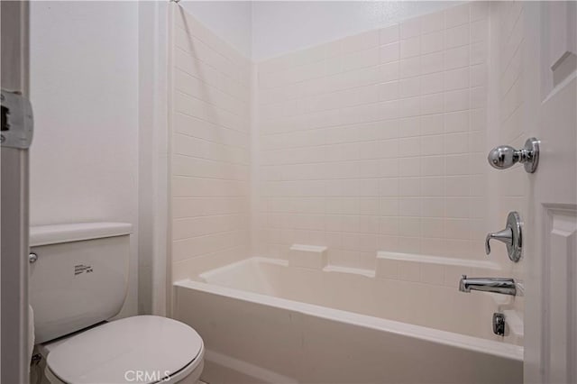 bathroom featuring shower / bathtub combination and toilet