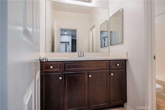 bathroom featuring vanity and toilet