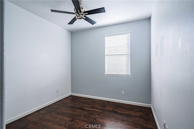 empty room with dark hardwood / wood-style floors and ceiling fan