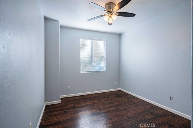 spare room featuring dark hardwood / wood-style floors and ceiling fan