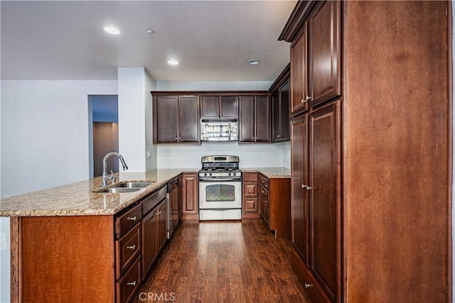 kitchen featuring dark hardwood / wood-style floors, light stone countertops, sink, and appliances with stainless steel finishes