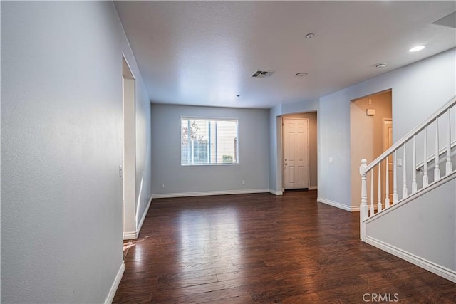 spare room with dark wood-type flooring