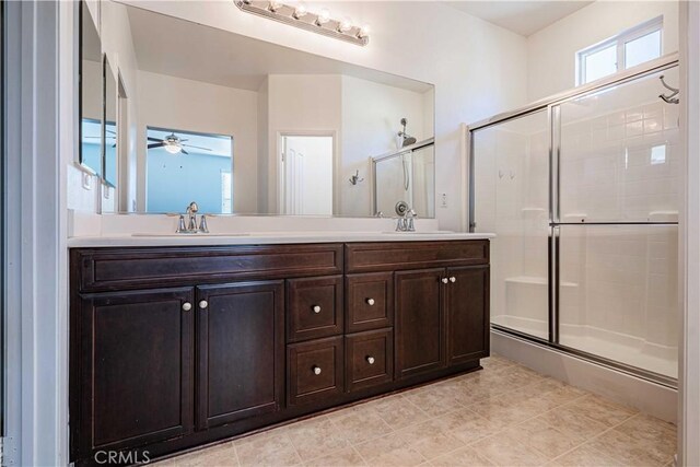 bathroom with ceiling fan, tile patterned flooring, vanity, and an enclosed shower