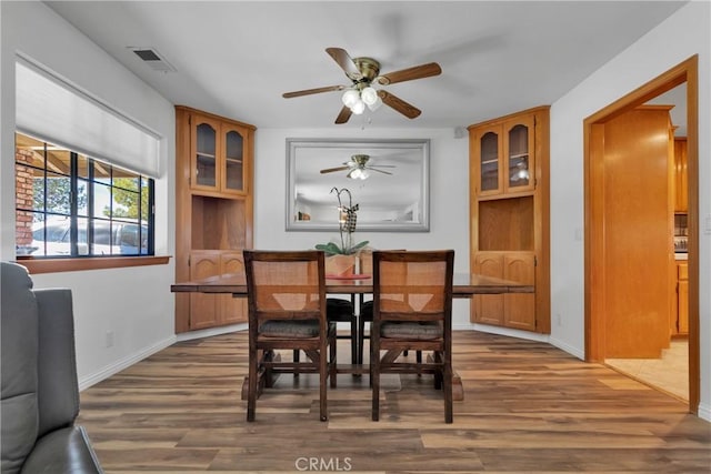 dining area featuring ceiling fan and dark hardwood / wood-style flooring