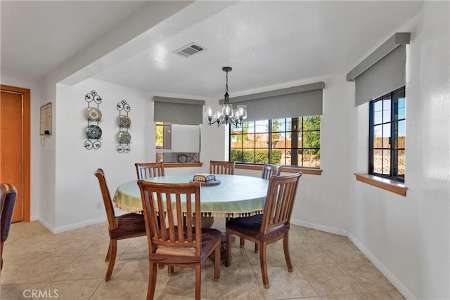 tiled dining area featuring a notable chandelier