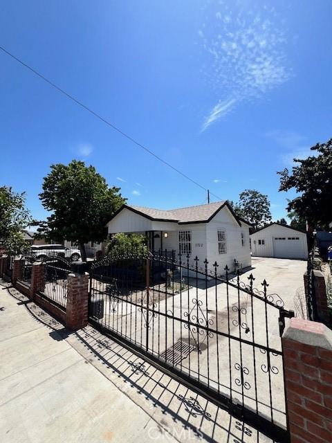 view of gate with an outbuilding