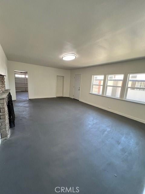 unfurnished room featuring a fireplace