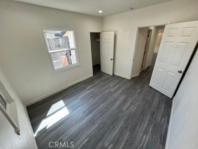 unfurnished bedroom featuring dark hardwood / wood-style flooring