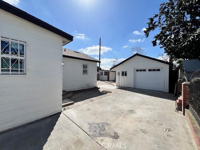 view of property exterior with a garage and an outdoor structure