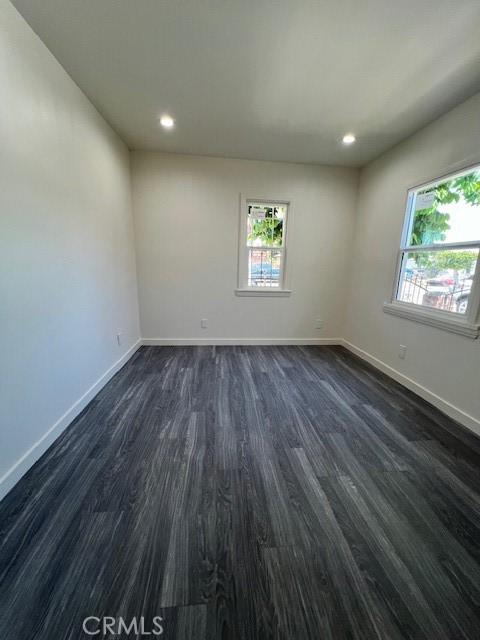 spare room with dark hardwood / wood-style floors