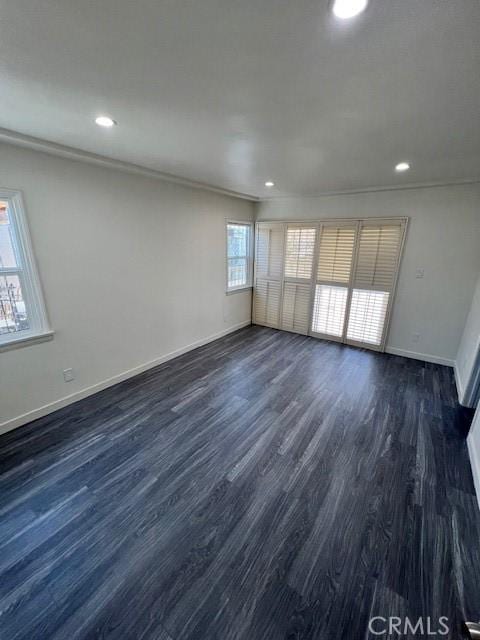 unfurnished room featuring dark hardwood / wood-style flooring and ornamental molding