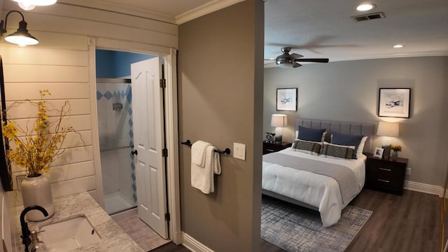 bedroom featuring crown molding, dark wood-type flooring, sink, and ceiling fan