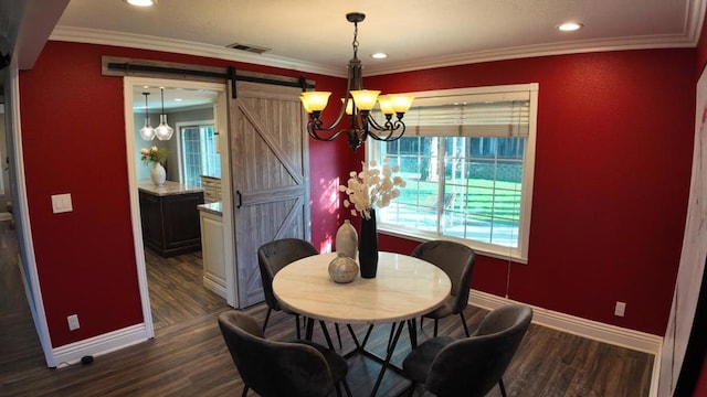 dining area featuring dark hardwood / wood-style floors, a barn door, a chandelier, and crown molding