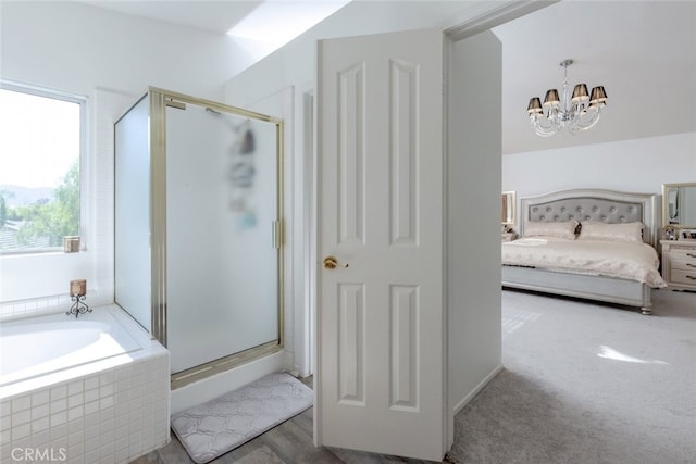 bathroom with a shower with shower door and a chandelier