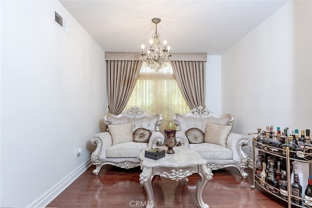 sitting room featuring dark hardwood / wood-style flooring and a notable chandelier