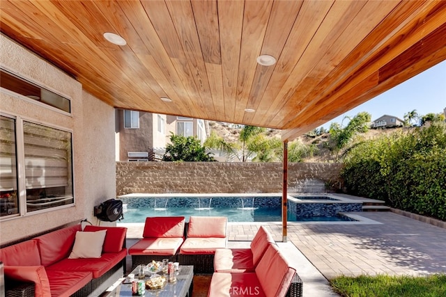 view of swimming pool featuring an outdoor hangout area, pool water feature, and a patio area