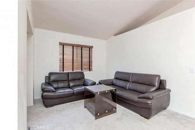 carpeted living room with lofted ceiling