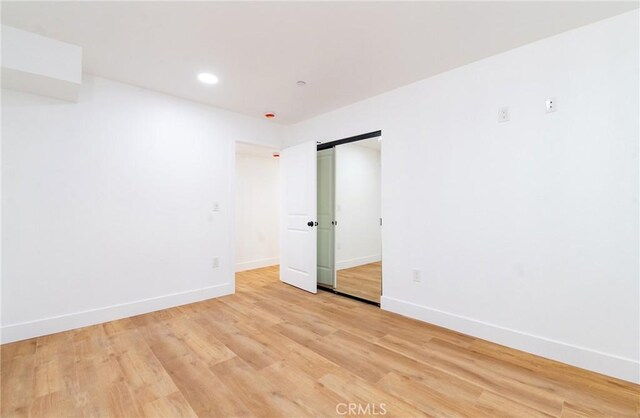 spare room with light wood-type flooring