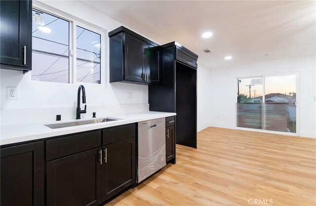 kitchen featuring light hardwood / wood-style floors, stainless steel dishwasher, and sink