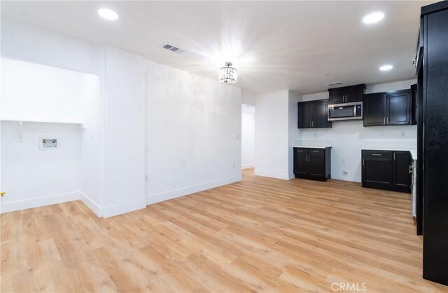 kitchen featuring a chandelier and light hardwood / wood-style flooring