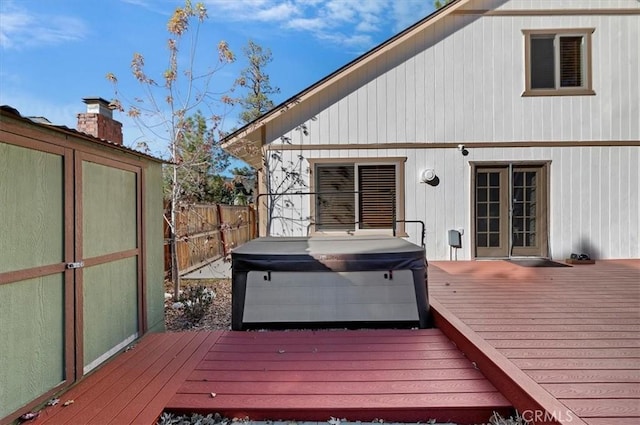 wooden deck with a hot tub