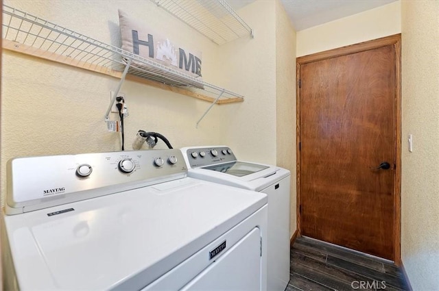 laundry room with separate washer and dryer and dark wood-type flooring