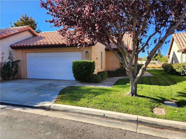 view of front of home with a front lawn and a garage