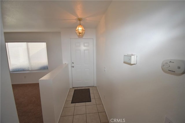 entryway with light tile patterned floors