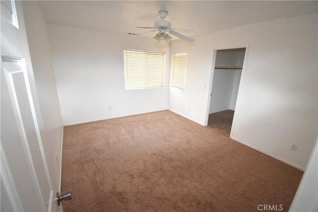 unfurnished bedroom featuring ceiling fan, a closet, and carpet flooring