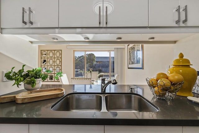 room details featuring sink and white cabinetry