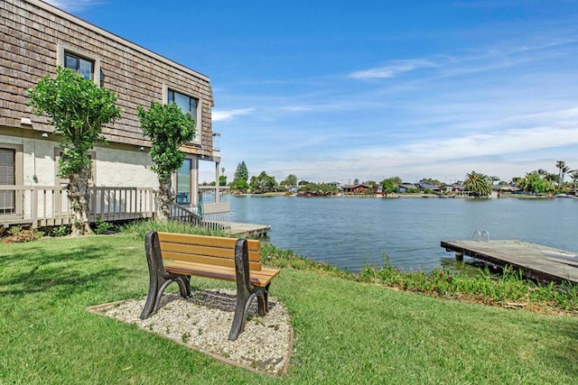 exterior space with a water view and a lawn