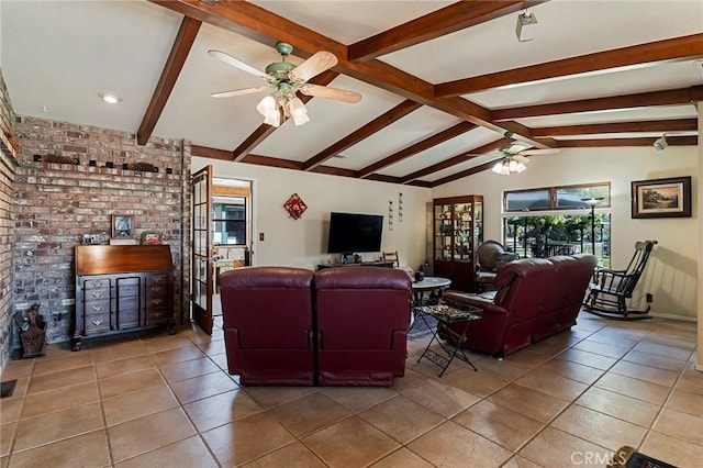 living room featuring vaulted ceiling with beams, ceiling fan, tile patterned flooring, and brick wall