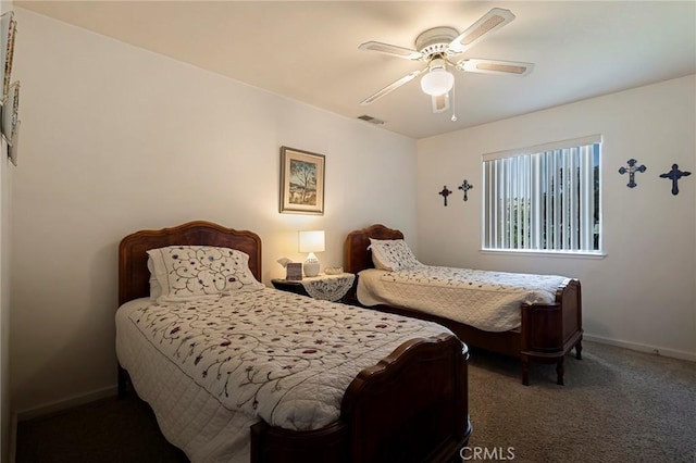 bedroom featuring dark colored carpet and ceiling fan