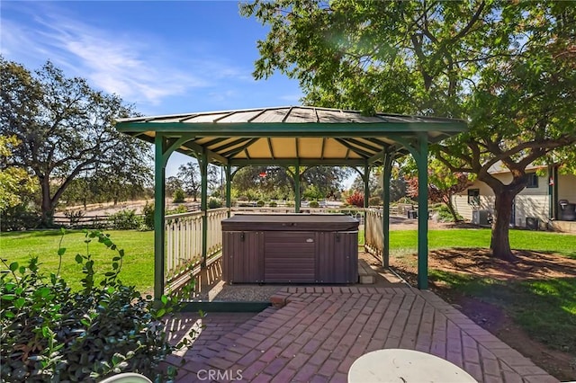 view of patio / terrace featuring a gazebo and a hot tub