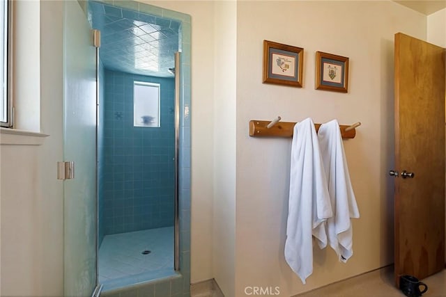 bathroom with a shower with shower door