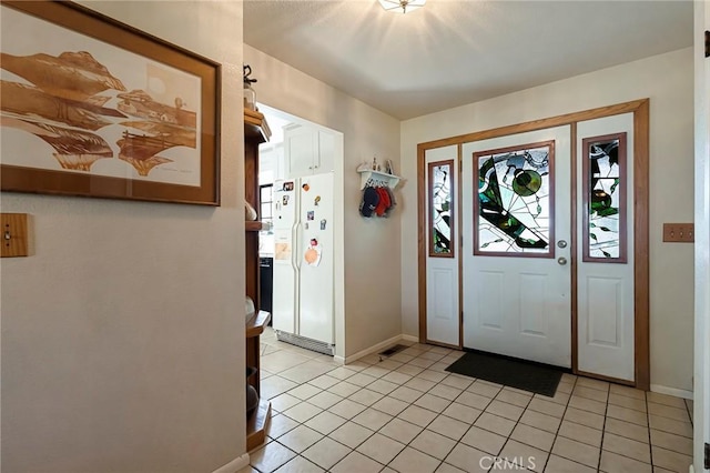 entryway with light tile patterned flooring